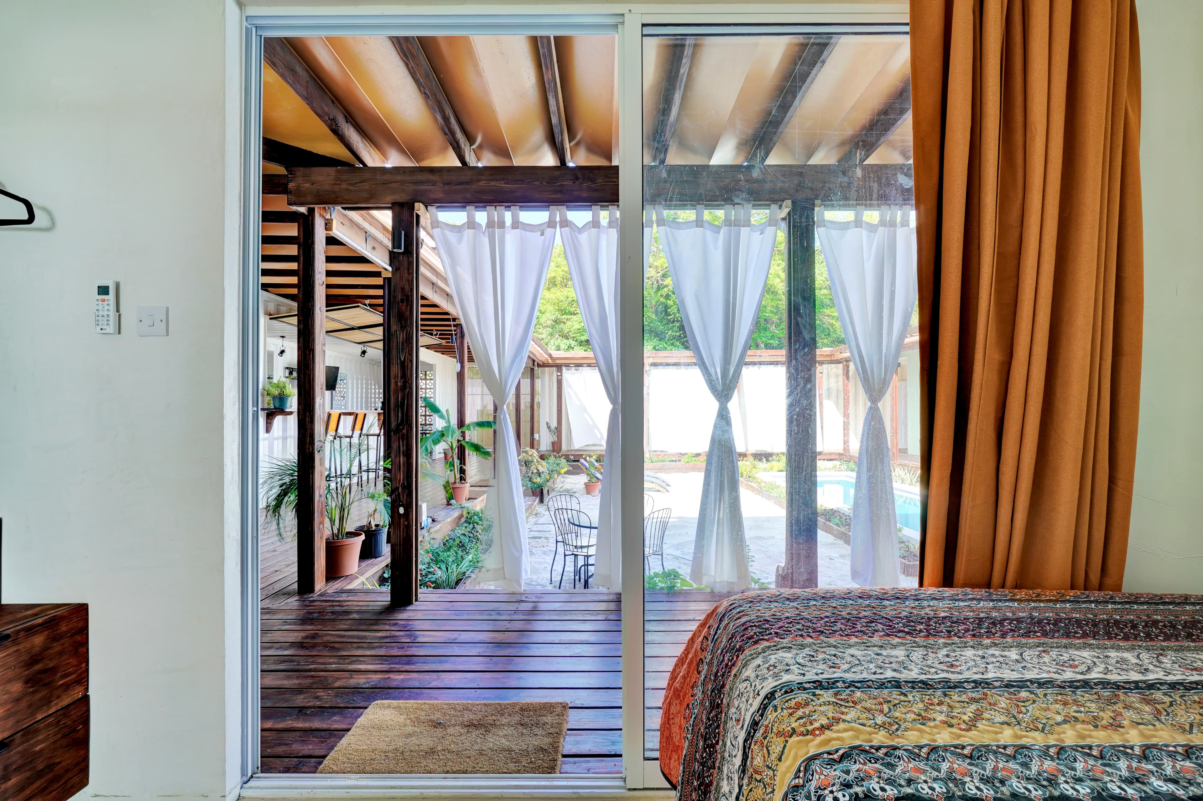 Spacious bedroom at Corten Villa overlooking the private pool and tropical garden