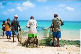 Grenadian fishermen with nets on the beach